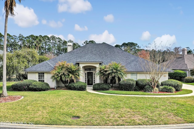 1625 Pinecrest Dr, Fleming Island, FL 32003 - single story home featuring a front yard, stucco siding, a chimney, and roof with shingles