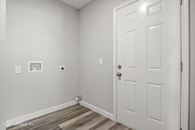 clothes washing area featuring baseboards, dark wood finished floors, electric dryer hookup, laundry area, and washer hookup