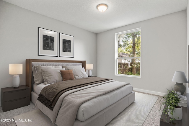 bedroom featuring baseboards and a textured ceiling
