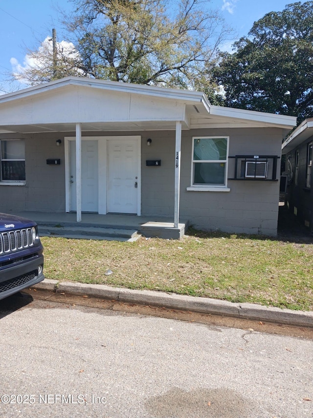 1419 Brady St Unit 1-2, Jacksonville, FL 32209 - view of front of home featuring covered porch, a front lawn, and concrete block siding