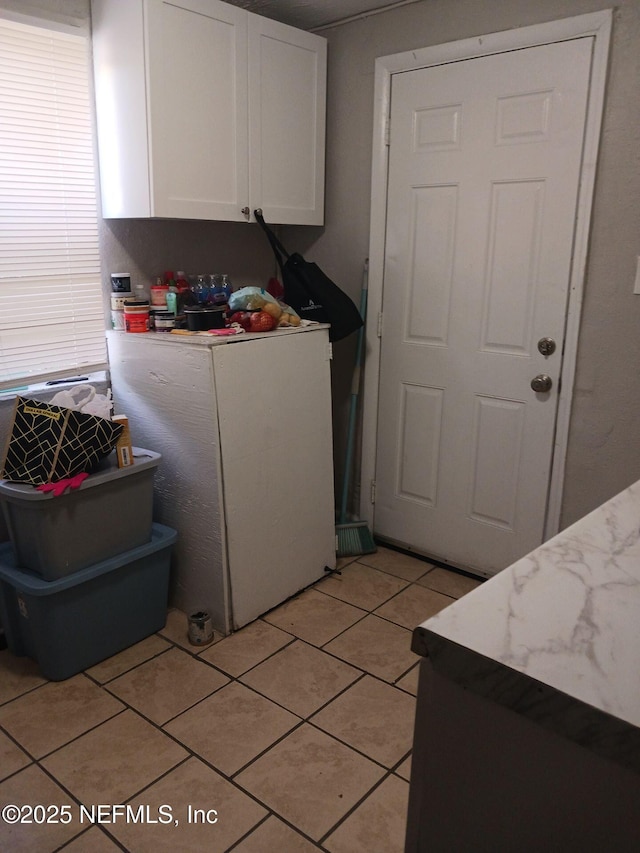 1419 Brady St Unit 1-2, Jacksonville, FL 32209 - kitchen featuring white cabinets, refrigerator, light countertops, and light tile patterned floors