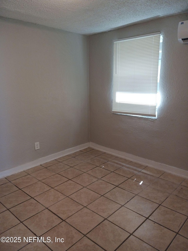 1419 Brady St Unit 1-2, Jacksonville, FL 32209 - spare room featuring an AC wall unit, baseboards, and a textured ceiling