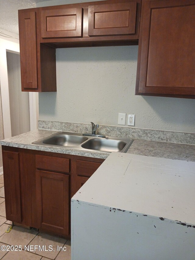 1419 Brady St Unit 1-2, Jacksonville, FL 32209 - kitchen with brown cabinets, light countertops, a sink, and light tile patterned floors
