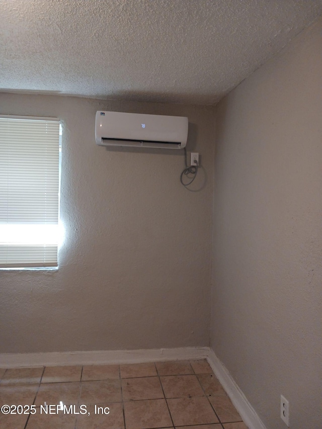 1419 Brady St Unit 1-2, Jacksonville, FL 32209 - room details featuring baseboards, a wall mounted AC, and a textured ceiling