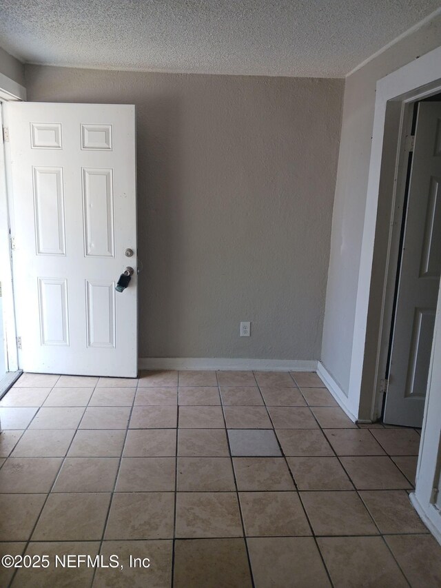 1419 Brady St Unit 1-2, Jacksonville, FL 32209 - unfurnished room featuring tile patterned flooring, a textured wall, baseboards, and a textured ceiling