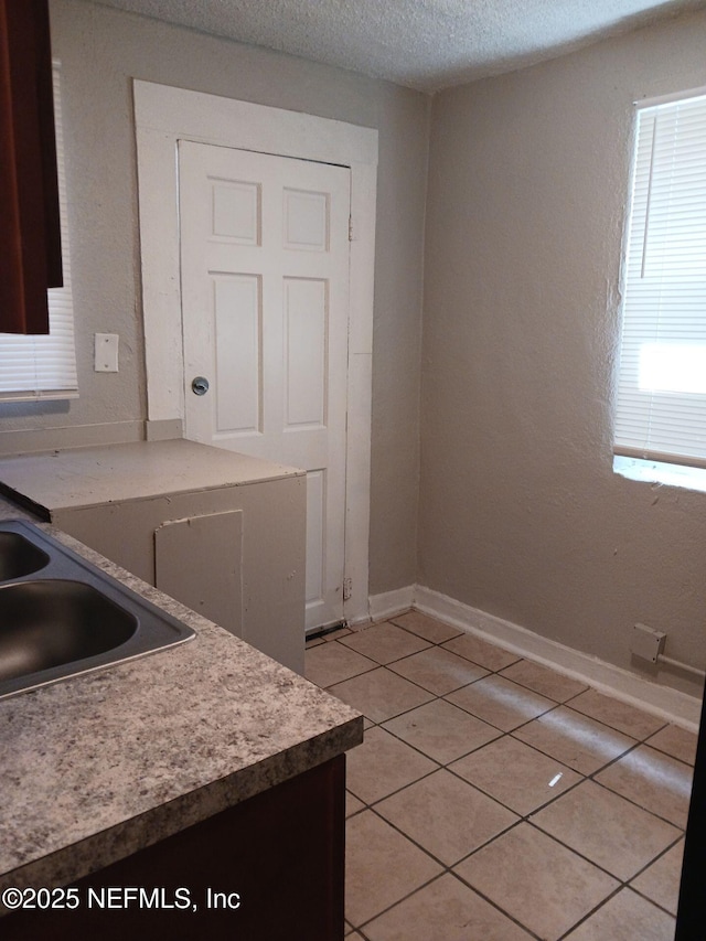 1419 Brady St Unit 1-2, Jacksonville, FL 32209 - kitchen with light tile patterned floors, baseboards, and a textured ceiling