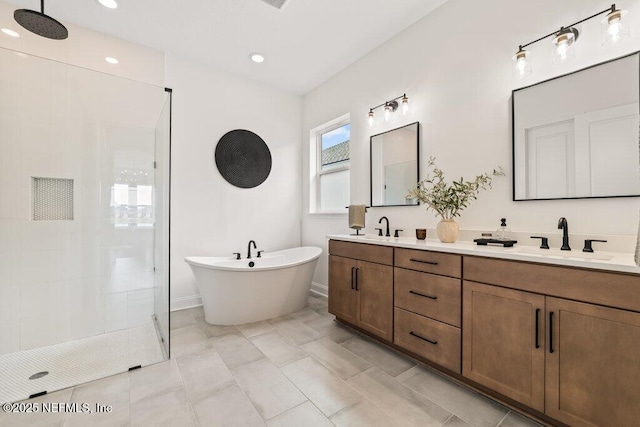full bath with walk in shower, double vanity, a sink, and a freestanding tub