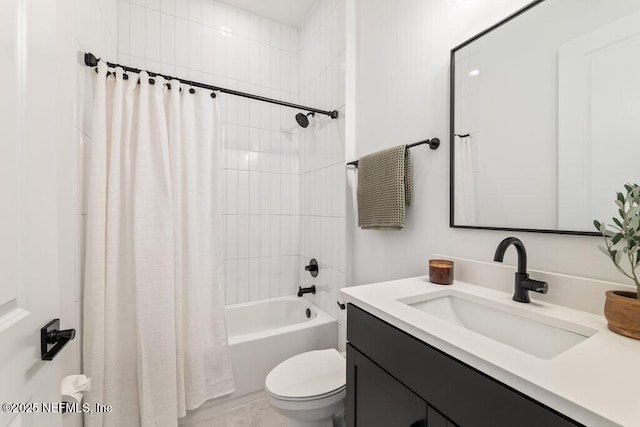 bathroom featuring shower / bath combo with shower curtain, toilet, and vanity