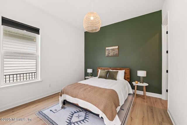 bedroom featuring baseboards and light wood-style floors