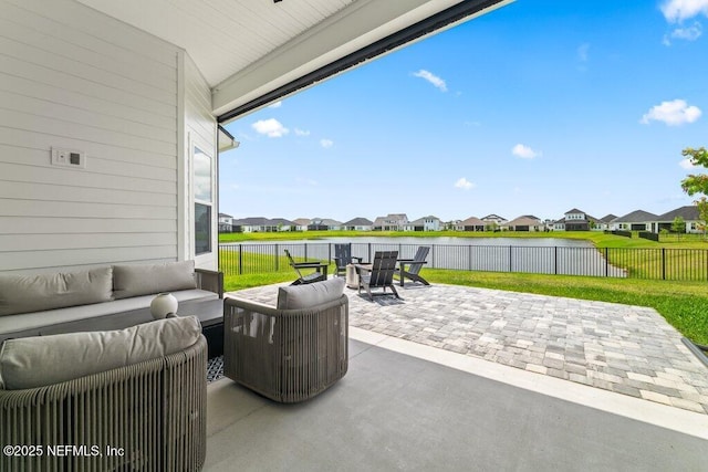 view of patio / terrace featuring a fenced backyard, a water view, a residential view, and an outdoor living space