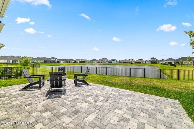 view of patio / terrace featuring a water view, a residential view, and a fenced backyard