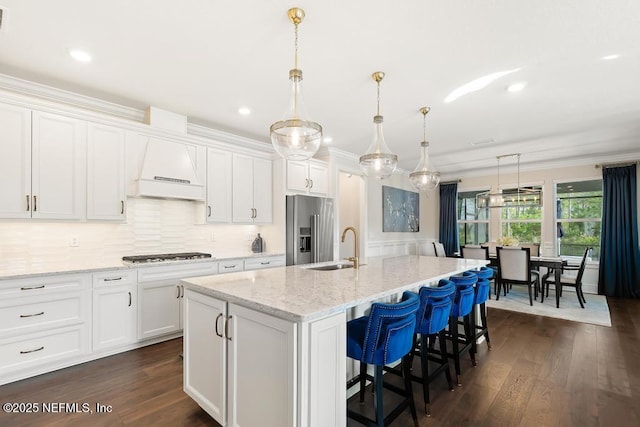 714 Curved Bay Trl, Ponte Vedra, FL 32081 - kitchen with stainless steel appliances, a kitchen island with sink, white cabinets, and dark wood finished floors