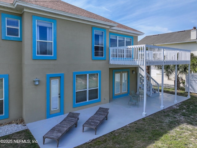 132 Beachside Dr, Ponte Vedra Beach, FL 32082 - back of property featuring a patio, a shingled roof, a wooden deck, and stucco siding