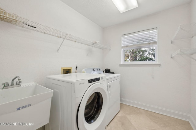 132 Beachside Dr, Ponte Vedra Beach, FL 32082 - clothes washing area with independent washer and dryer, a sink, baseboards, and laundry area