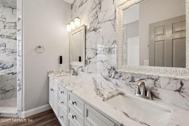 132 Beachside Dr, Ponte Vedra Beach, FL 32082 - full bathroom with double vanity, wood finished floors, a sink, and a marble finish shower