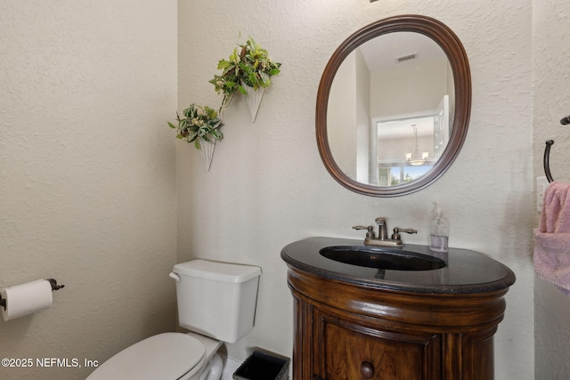 132 Beachside Dr, Ponte Vedra Beach, FL 32082 - half bath featuring a textured wall, visible vents, toilet, and vanity