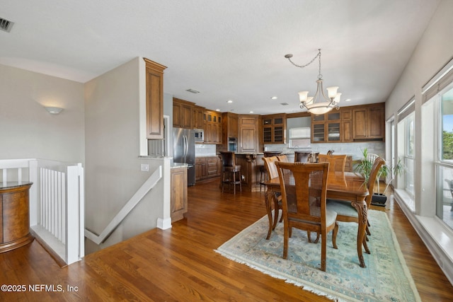 132 Beachside Dr, Ponte Vedra Beach, FL 32082 - dining space with a notable chandelier, visible vents, recessed lighting, and dark wood-style flooring