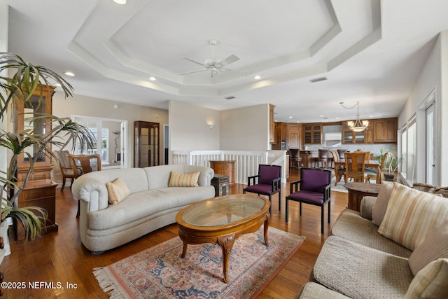 132 Beachside Dr, Ponte Vedra Beach, FL 32082 - living area with light wood finished floors, ceiling fan with notable chandelier, recessed lighting, and a raised ceiling
