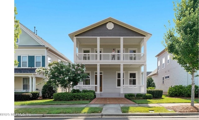 0 W 12th St, Jacksonville, FL 32206 - view of front of home featuring covered porch, a balcony, and a front lawn