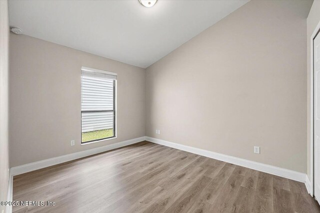 2931 Lantana Lakes Dr W, Jacksonville, FL 32246 - unfurnished room featuring baseboards, lofted ceiling, and wood finished floors