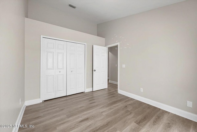 2931 Lantana Lakes Dr W, Jacksonville, FL 32246 - unfurnished bedroom featuring baseboards, light wood-style flooring, and a closet