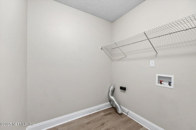 2931 Lantana Lakes Dr W, Jacksonville, FL 32246 - clothes washing area featuring washer hookup, a textured ceiling, light wood-style flooring, laundry area, and baseboards
