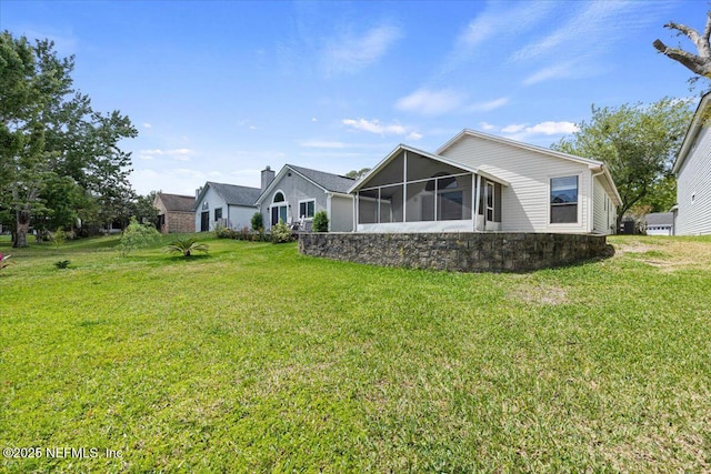 2931 Lantana Lakes Dr W, Jacksonville, FL 32246 - back of house with a lawn and a sunroom