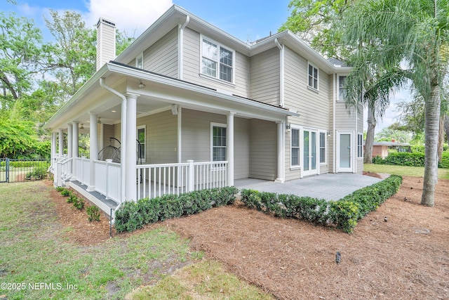 1204 San Amaro Rd, Jacksonville, FL 32207 - view of side of property with a porch, a chimney, and a patio area