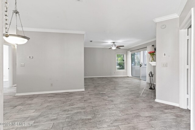 interior space featuring crown molding, a ceiling fan, and baseboards