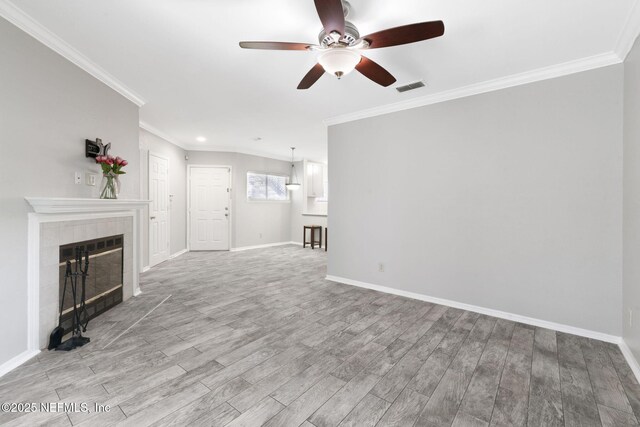 unfurnished living room featuring ceiling fan, visible vents, ornamental molding, and wood finished floors