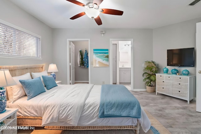 1800 The Greens Way Unit 407, Jacksonville Beach, FL 32250 - bedroom with ensuite bath, ceiling fan, and baseboards