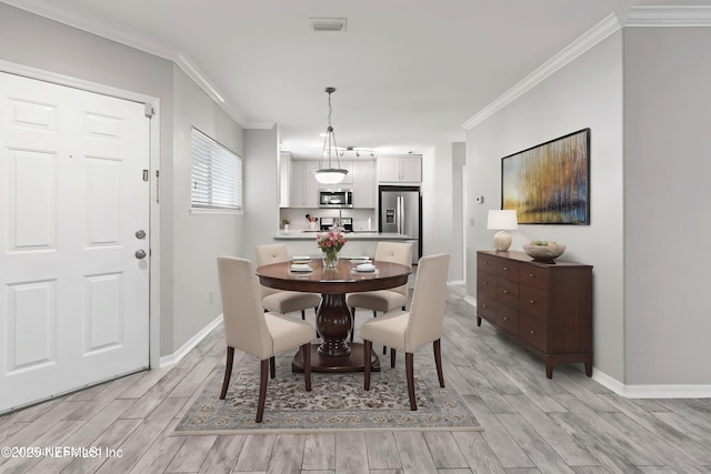 1800 The Greens Way Unit 407, Jacksonville Beach, FL 32250 - dining area featuring crown molding, light wood-style floors, and baseboards