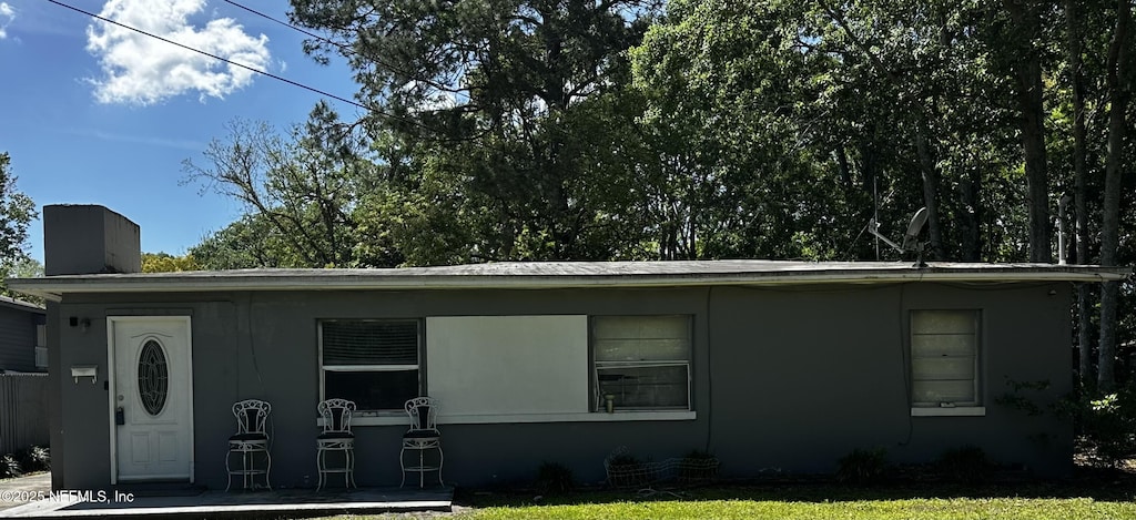 3026 E Detroit Cir, Jacksonville, FL 32254 - ranch-style house with a front lawn and a chimney