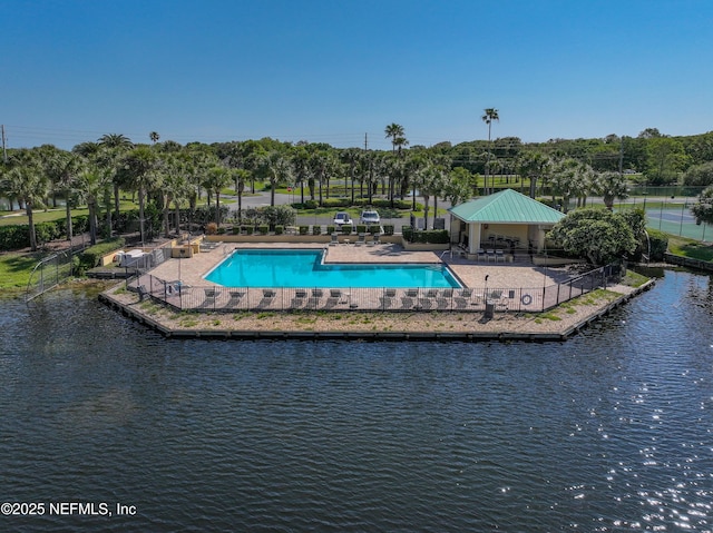 pool featuring a water view, a gazebo, and fence