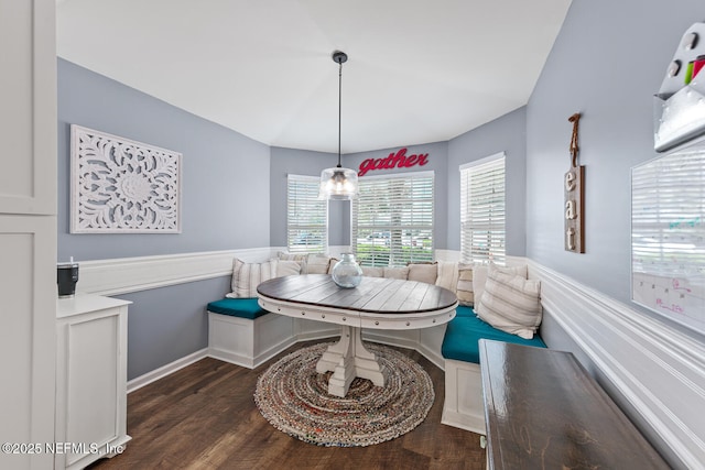 dining area with dark wood-type flooring, breakfast area, and baseboards