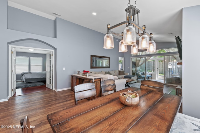 dining space featuring baseboards, vaulted ceiling, recessed lighting, visible vents, and wood finished floors