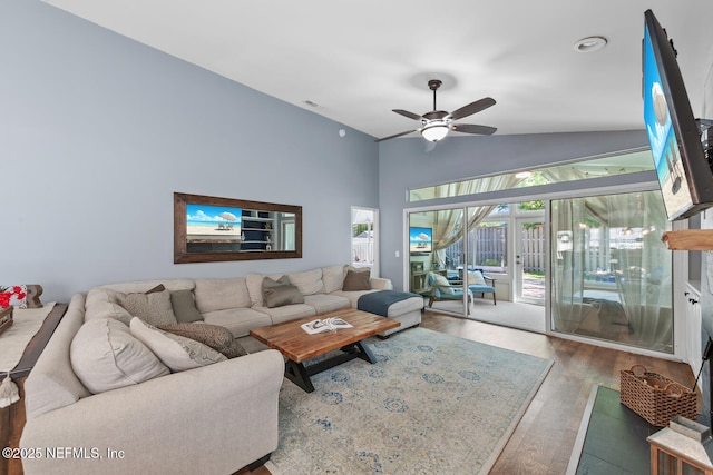 living room with visible vents, a ceiling fan, vaulted ceiling, and wood finished floors