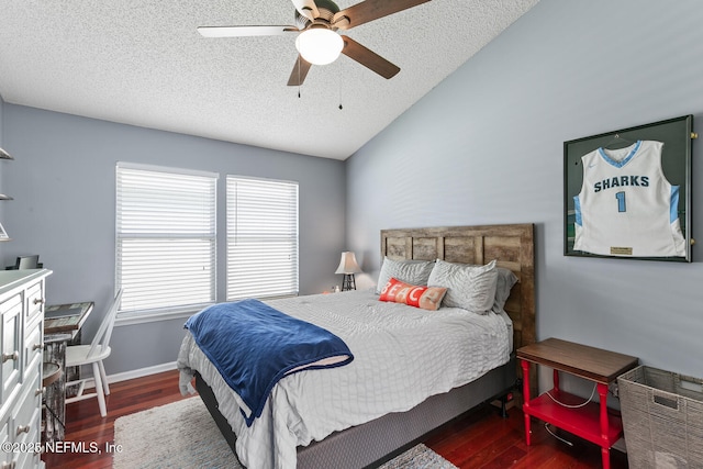 bedroom with a textured ceiling, wood finished floors, a ceiling fan, and vaulted ceiling