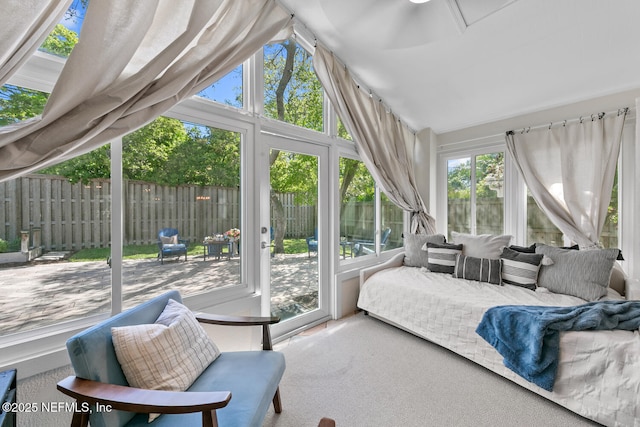 sunroom / solarium featuring outdoor lounge area, carpet floors, and lofted ceiling