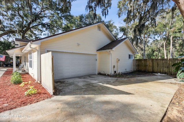 96033 River Marsh Bnd, Fernandina Beach, FL 32034 - view of home's exterior featuring a garage, fence, and concrete driveway