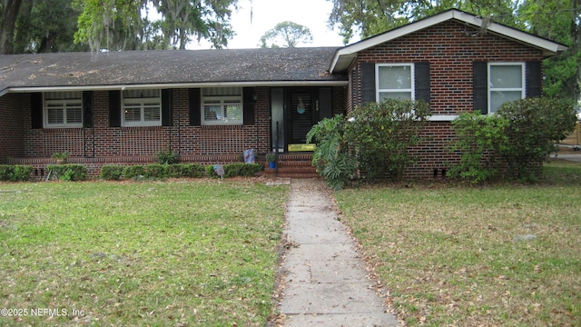 ranch-style home featuring brick siding and a front yard