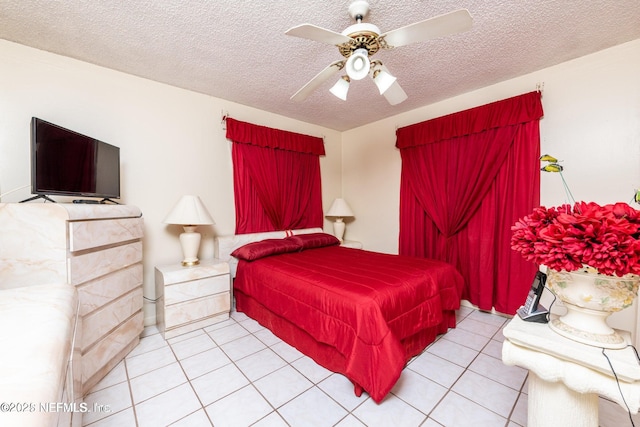 tiled bedroom with a textured ceiling and a ceiling fan