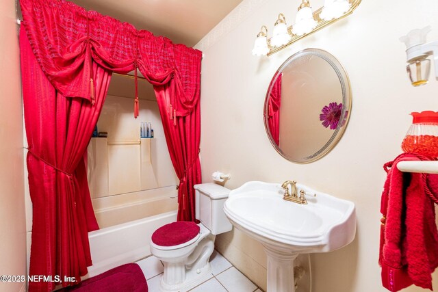 bathroom with shower / bath combination with curtain, tile patterned flooring, and toilet