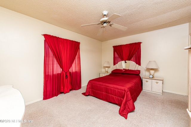 bedroom with carpet flooring, baseboards, ceiling fan, and a textured ceiling