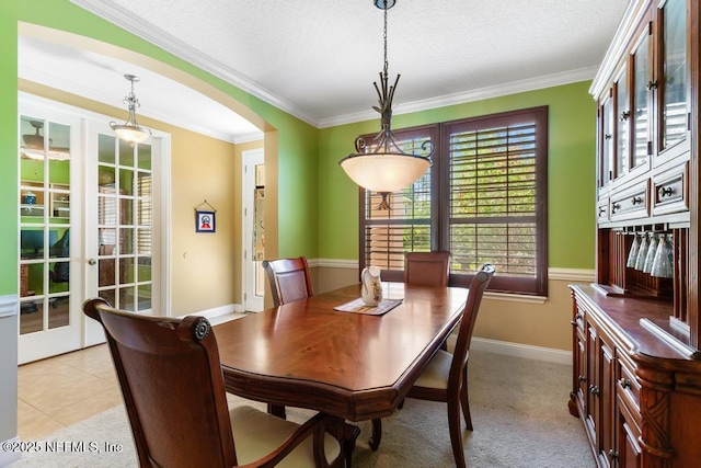 420 Chattan Way, Saint Johns, FL 32259 - dining room featuring crown molding, arched walkways, a textured ceiling, light tile patterned flooring, and baseboards