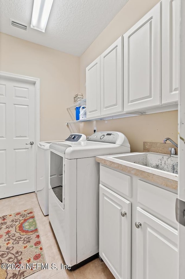 420 Chattan Way, Saint Johns, FL 32259 - laundry area with a textured ceiling, visible vents, a sink, cabinet space, and washer and clothes dryer