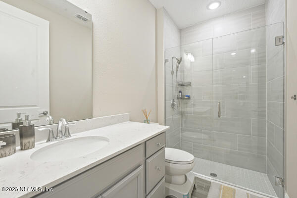 73 Lily Landing Dr, Saint Augustine, FL 32092 - full bath with vanity, visible vents, toilet, and a shower stall