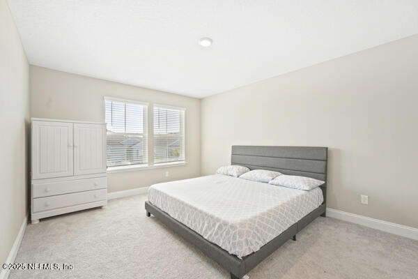 73 Lily Landing Dr, Saint Augustine, FL 32092 - carpeted bedroom featuring baseboards