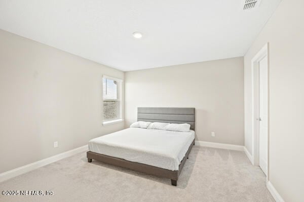 73 Lily Landing Dr, Saint Augustine, FL 32092 - bedroom with light carpet, baseboards, and visible vents