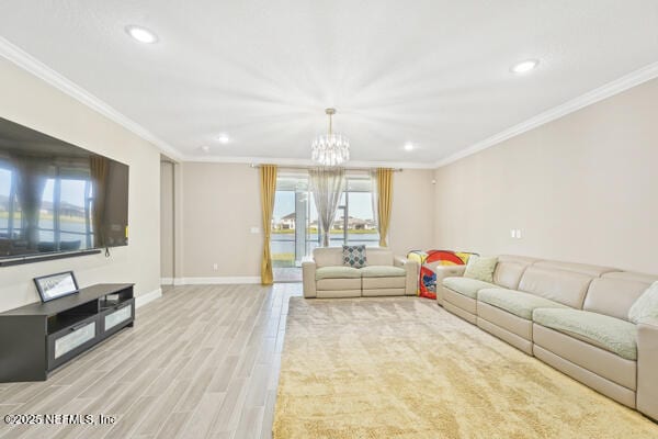 73 Lily Landing Dr, Saint Augustine, FL 32092 - living room featuring crown molding, recessed lighting, an inviting chandelier, baseboards, and light wood-style floors